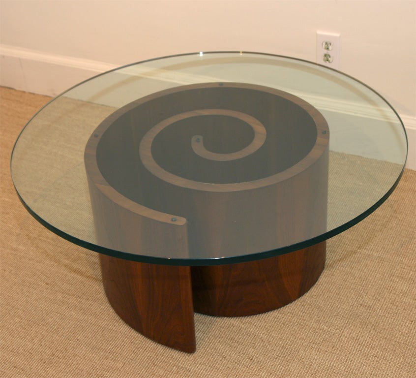 The spiral steam bent wooden support, with a circular glass top.