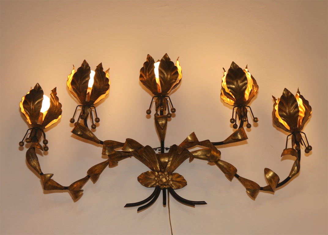 Hollywood Regency large 5-arm sconce in gilt iron, uses candelabra type bulbs.
