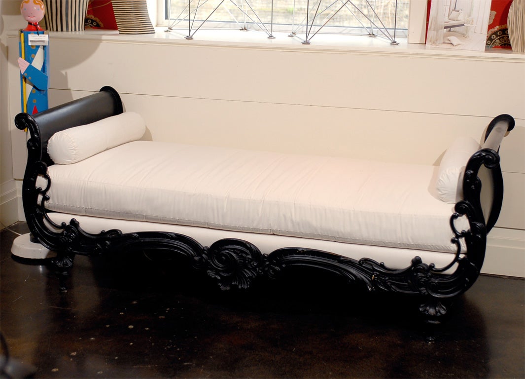 Beautiful French painted iron daybed with raised decorative detail.
