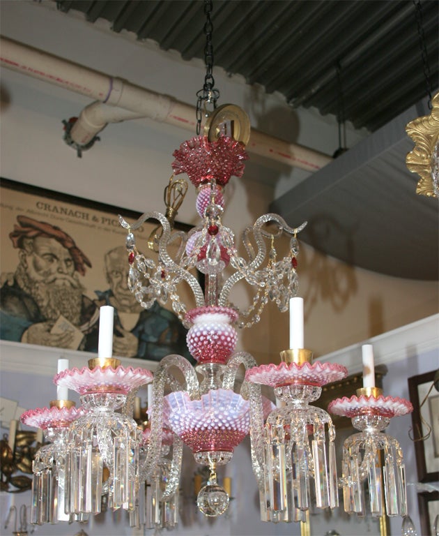 What a find!   This magnificent cranberry glass chandelier is attibuted to the Fenton glass company.   The six arms are newly rewired and in perfect condition.   Each light can take at least 40 watts.  This fixture is loaded with color,