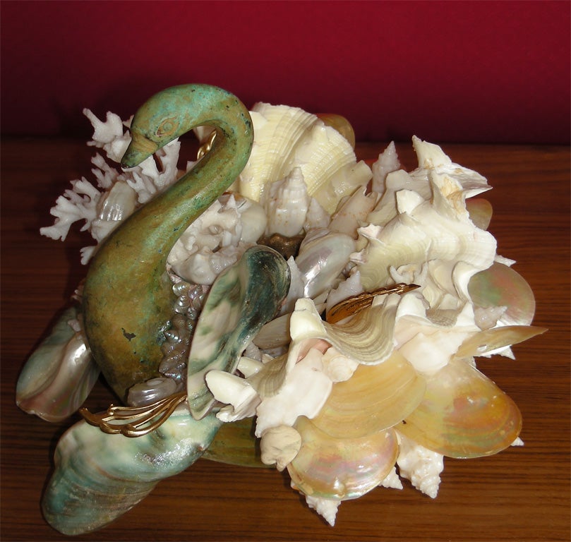 Two swan-shaped candlesticks made by Frédérique Lombard Morel in bronze and different varieties of shells.