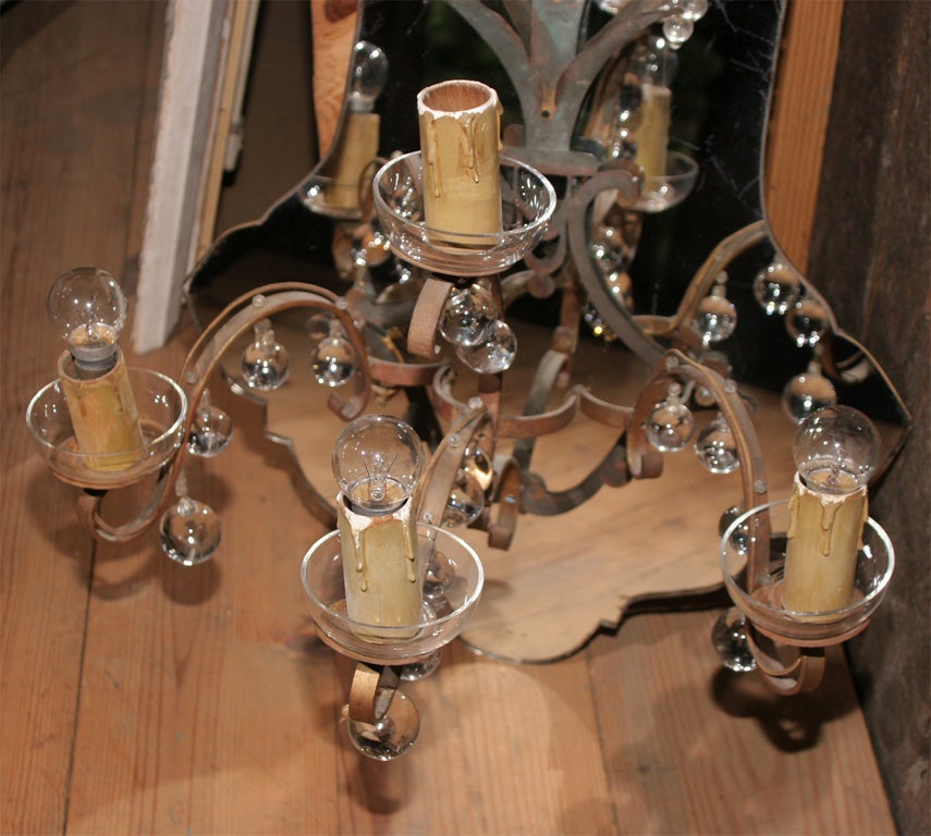 Large French medallion shaped mirror back sconce with three lights and glass ball drops.
One tiny glass ball is missing from the gilt foliate decoration on back plate. This piece is partially electrified.
 