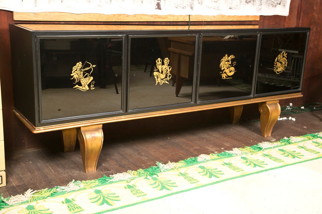 French four eglomise door buffet on a gilt four legged platform.