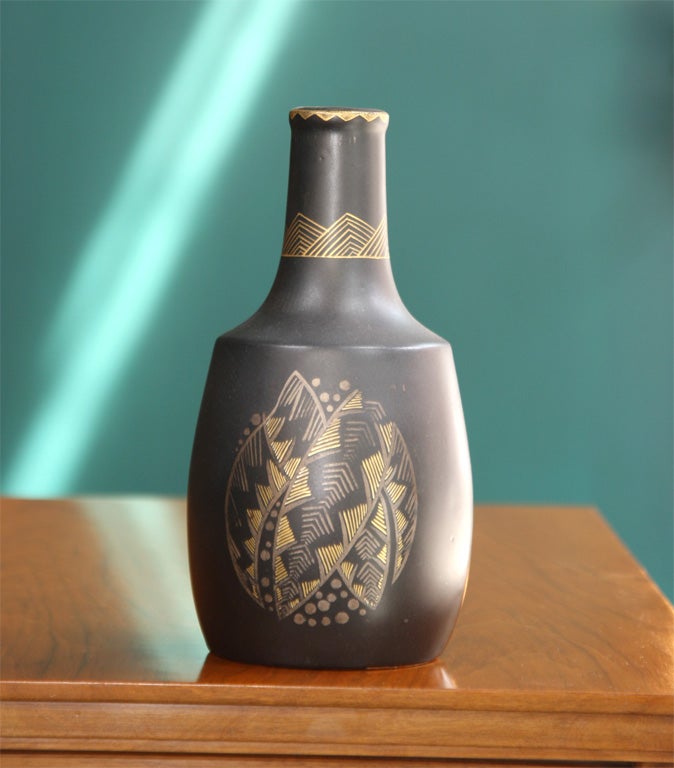 Ceramic bottle-form vase decorated with foliate forms and gold accents. By Jean Luce, French 1925; 10.75