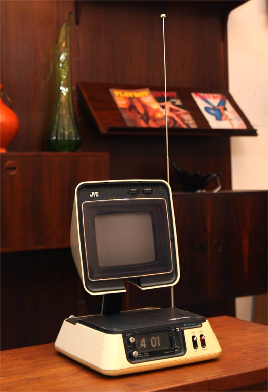 Very mod TV/ Alarm Clock in the shape of a pyramid with a flip top.  VHF input.