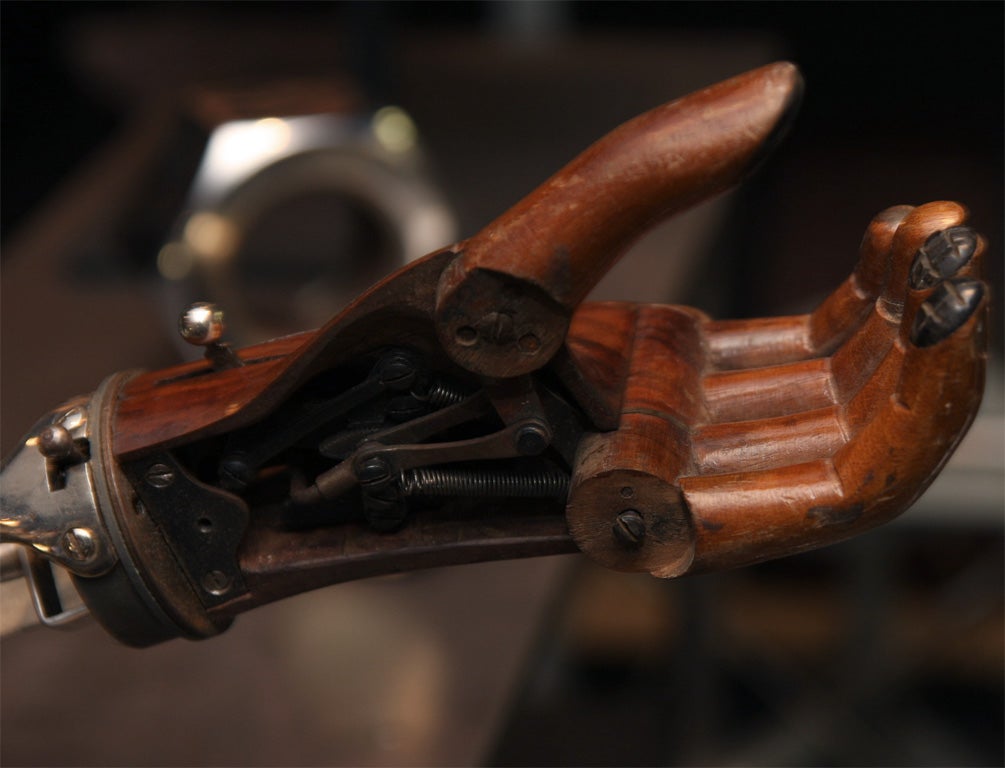 A great, mechanical, early prosthetic arm and hand out of wood and metal cutaway to demonstrate mechanism. Possibly 19th century.