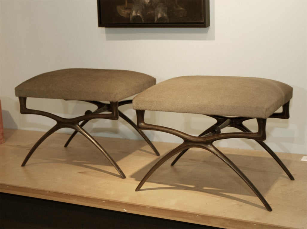 Elegant benches with organically shaped bronze bases. These studio made pieces are created individually to order and are the original design from the 