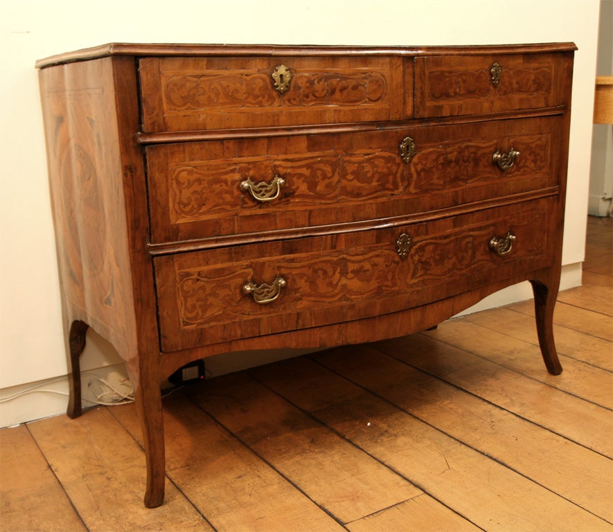 A Neoclassical Four Drawer Mahogany and Fruitwood Commode