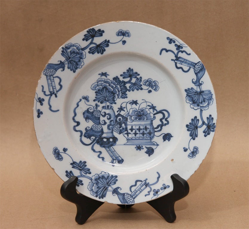 Fine 18th Century English delft plate of a Chinese pattern, the order decorated with flowering vases and scrolls, the center decorated with flowered vases and pots, bright crisp decoration.