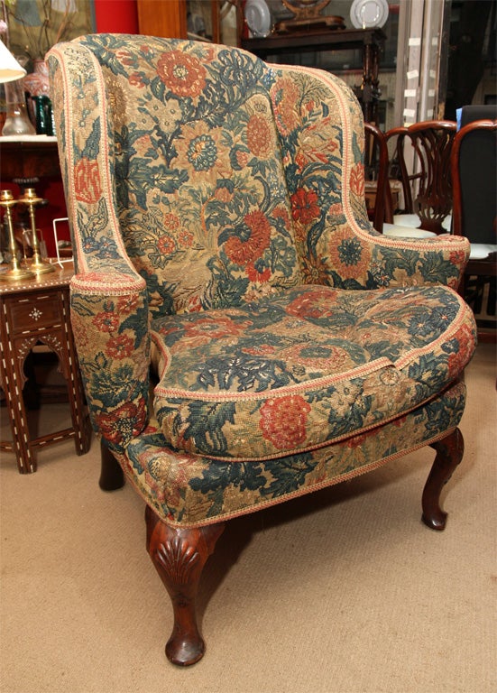 Fine George I walnut wing chair covered in contemporary needlework, circa 1730, the cabriole legs with shell carved knees and ending in pad feet, the back legs of stout and downswept form, the needlework in very good condition and retaining vibrant