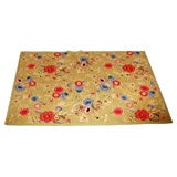 vintage hooked rug with brightly colored flowers