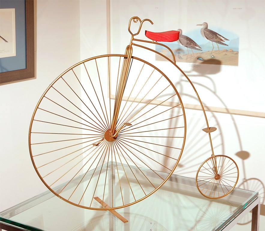 A signed  Curtis Jere High Wheel Bicycle with red seat. Free standing or wall hanging. It adds spice to any room!
