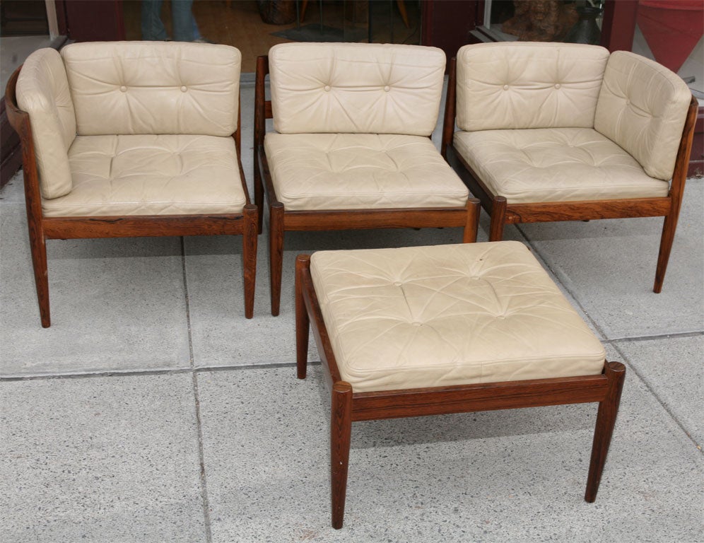 Unusually configured sofa set consisting of two corner chairs, one center chair with stool, can be used in different configurations.  The frames of the chairs are beautifully curved rosewood