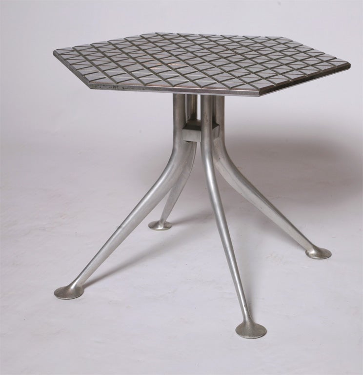 Alexander Girard table originally conceived for Braniff Airlines.<br />
Girard's furniture designs were produced by Herman Miller for <br />
only two years. Cast and Plated Aluminum
