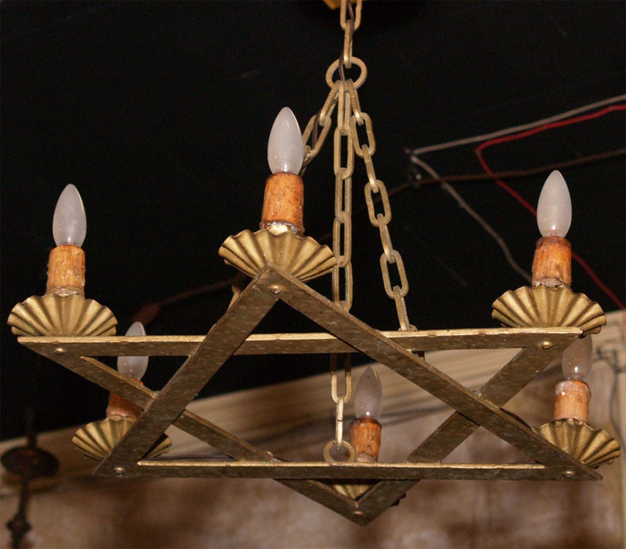 Made of hammered iron painted a dark gold color.