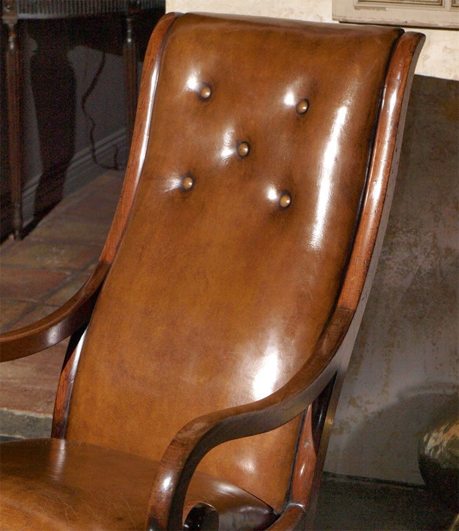 Antique English Regency mahogany leather rocking chair.