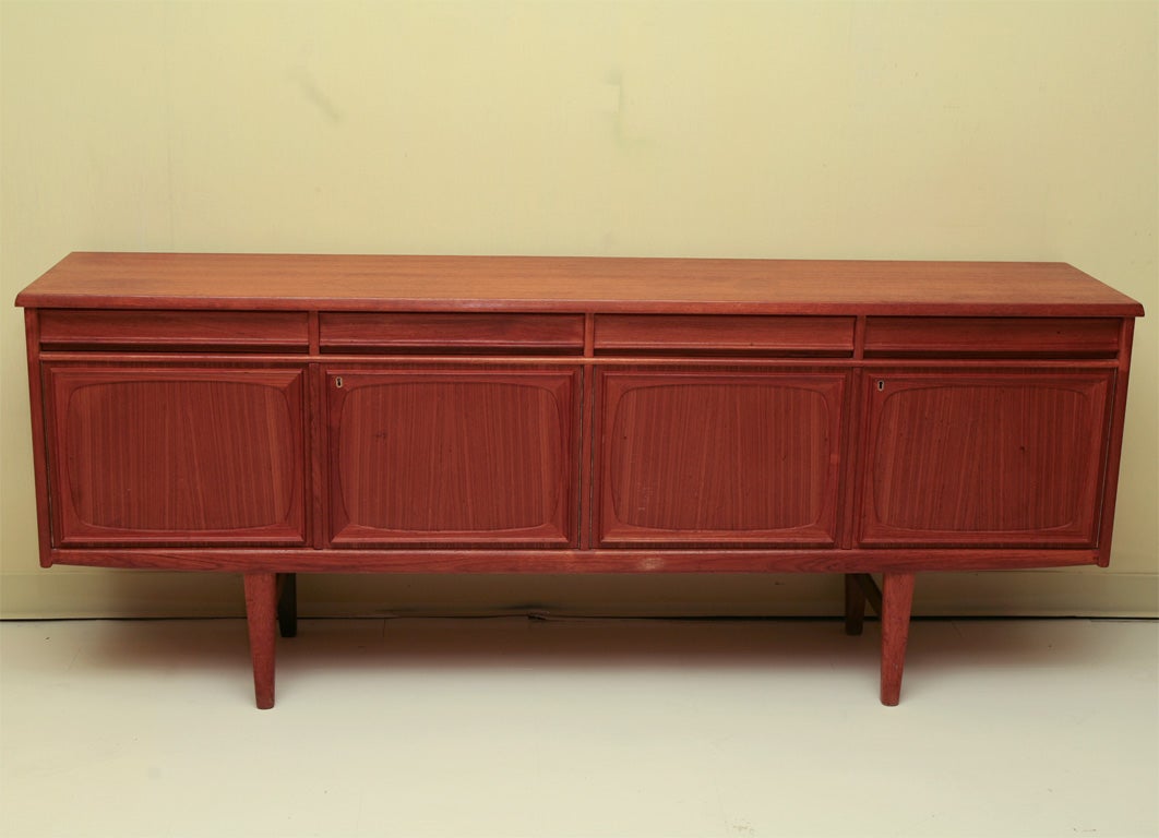 Nice compact sized Danish modern sideboard in teak wood with four cutlery drawers and four cupboards with interior shelving, mid-20th century.