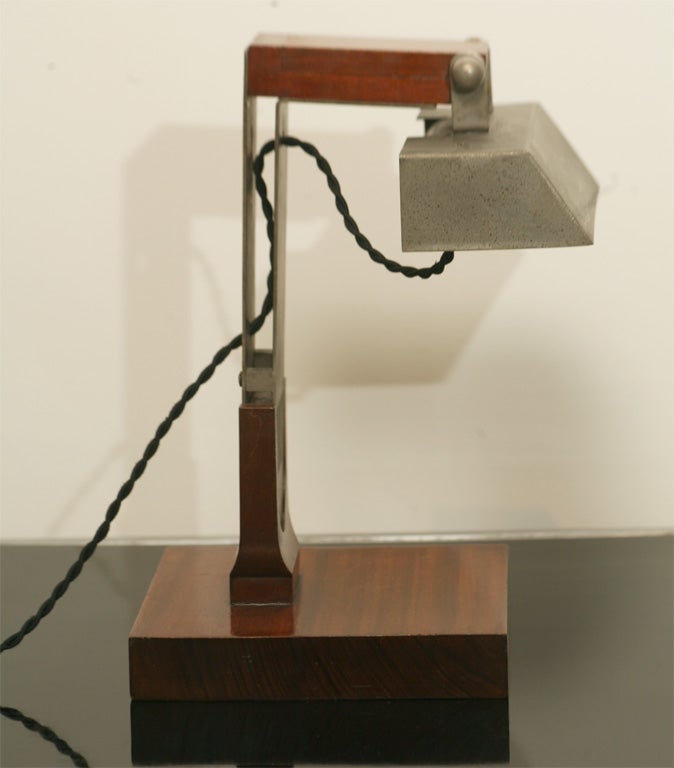 Very rare desk or wall lamp designed by one of the most important French avant-garde Modernist innovator, Jacques Le Chevallier in 1926-28.

Solid mahogany base with aluminum arm and shade. 

Sold in Tajan in November 2006. Reference: 