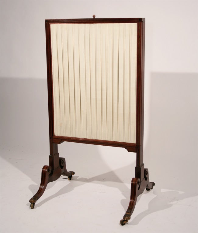 A Late Regency Mahogany Three-Slide Expanding Firescreen on Splayed Joined Feet with Brass Castors Lined with Pleated Cream Silk

Each adjust able panel 26''H x 21''W