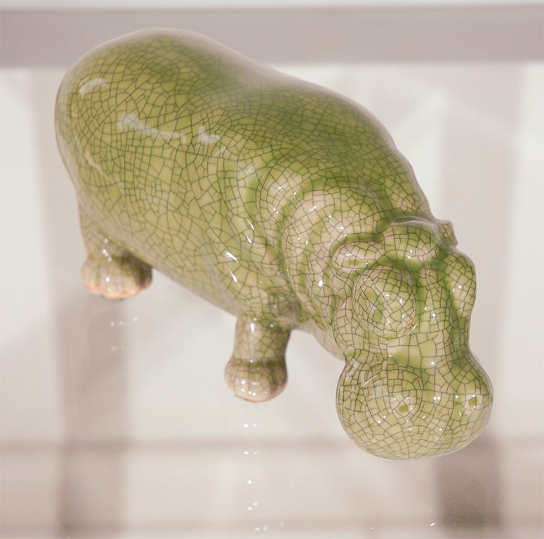 An adorable ceramic hippo figure in a green celadon crackle glaze. Unmarked.