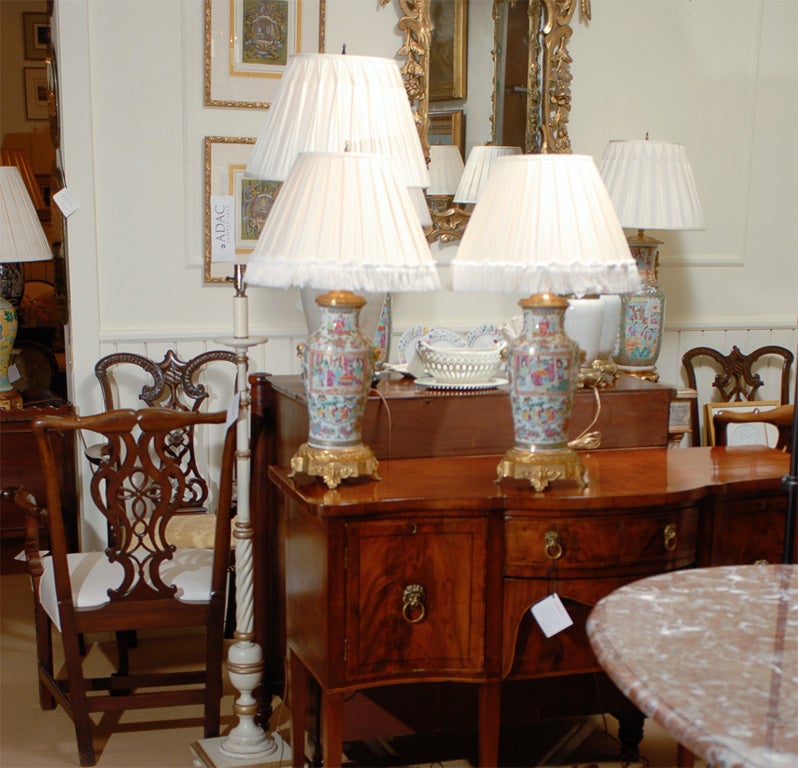A pair of Chinese Canton/famille rose/rose medallion vases with French bronze dore mounts wired as lamps with silk shades