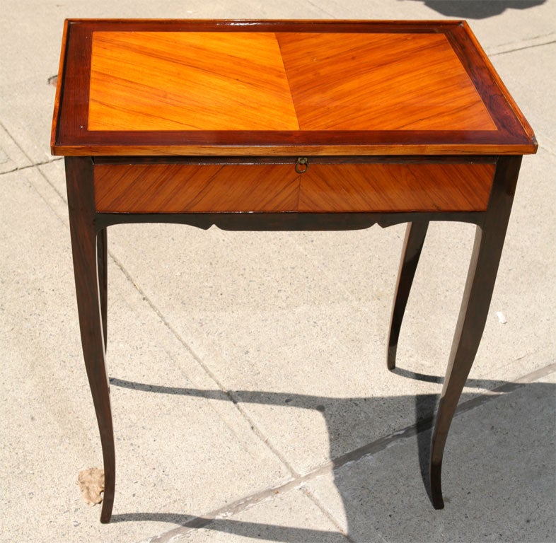 This finely made Louis XV style side table is of mahogany and kingwood. The proportions are very refined and its dramatic dark wood banding offsetting the king wood central panels creates a table with a sense of impact far greater than the actual
