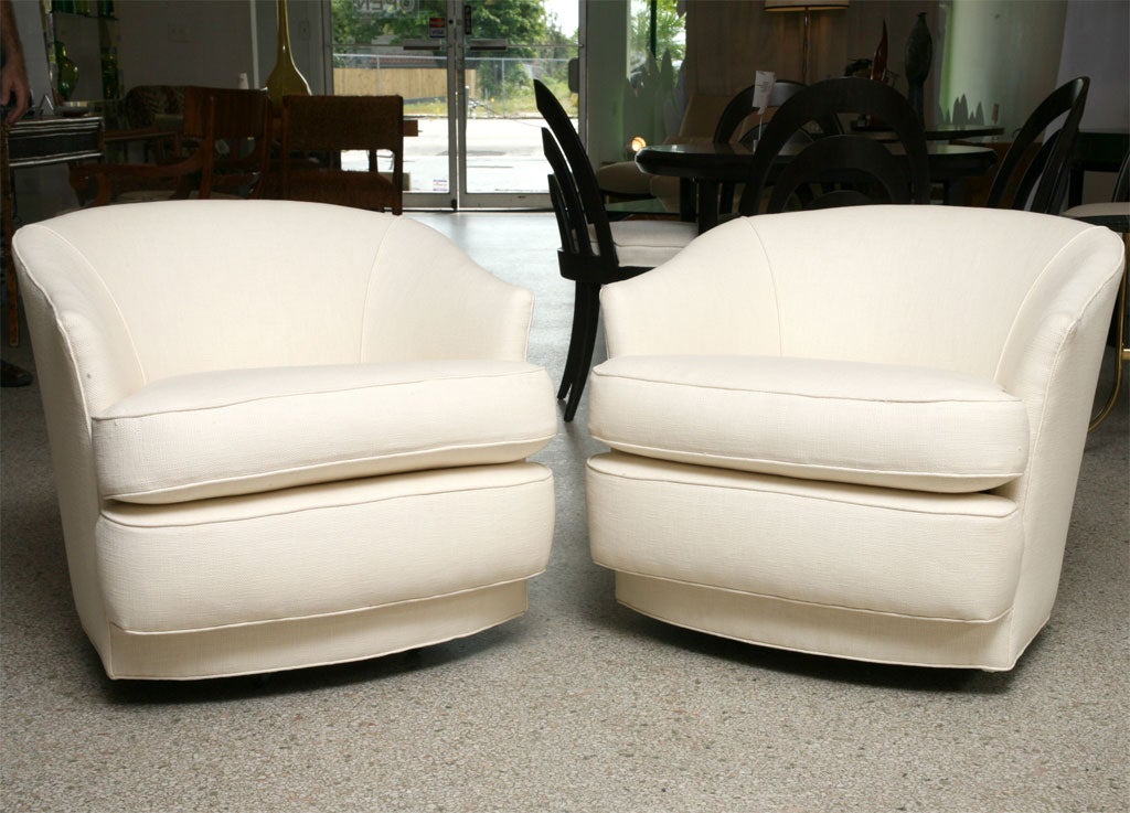 Pair of lounge chairs by John Stuart, New York.  Swivel base, wheels.<br />
<br />
***Contact/Shipping Information: AOL (American Online) users may experience difficulties sending emails to us or receiving emails from us. If you have made an