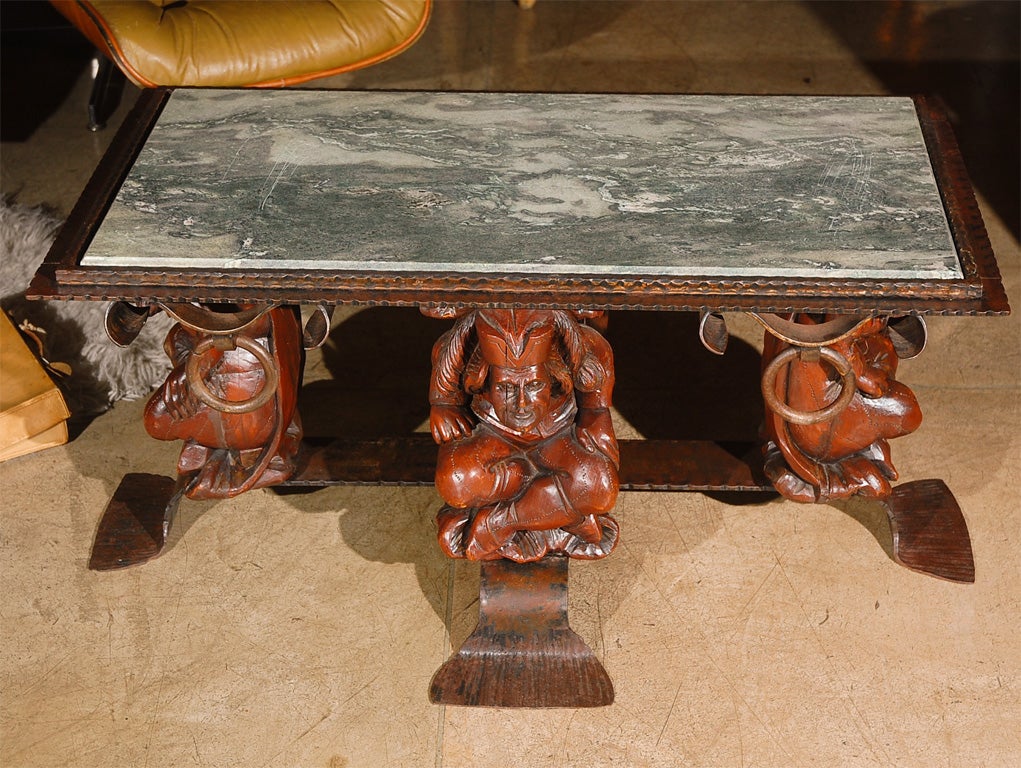 French coffee table with green marble top, hammer metal ring and four gargoyles design. Gargoyles are made in foam composition. Attributed to Jean-Maurice Rothschild.