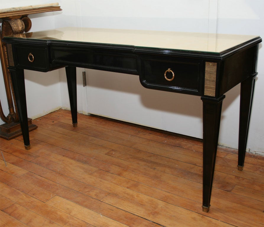 A very sleek directoire style gold mirrored top bureau plat by Jansen.  Bronze mounted with two drawers.