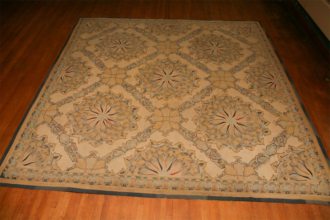 This  antique Abusson carpet is in a fine state of preservation. Presented as found the rug is directly out of a up state New York home. The pattern is a woven overall trellis without any central medallion. The trellised open areas are filled with