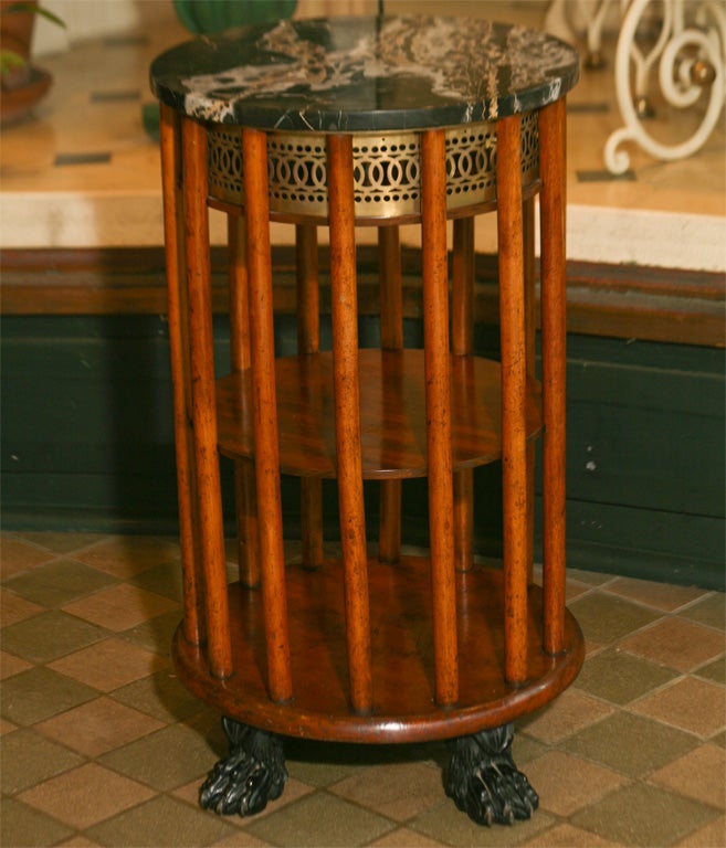 This very nice table modified from a period regency planter makes a great statment in a small area. The table is of mahogany with a nice faded color that compliments the brass grill liner that would have held the orginal metal liner for planting. A