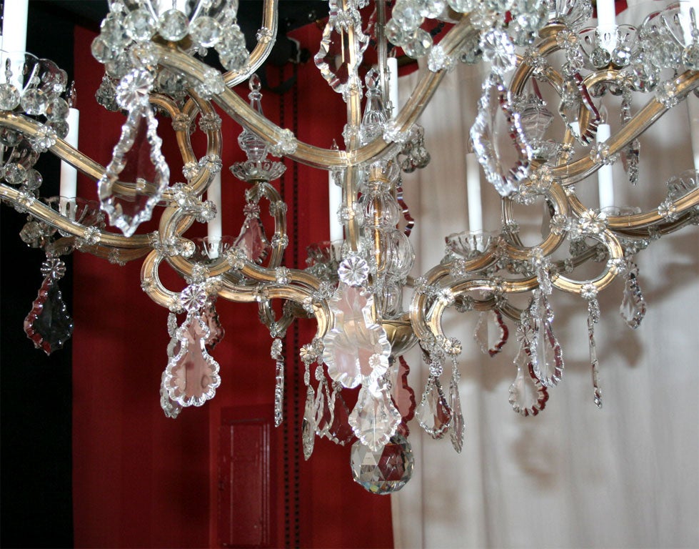 French Maria Teresa gilded iron and crystal sixteen light chandelier.