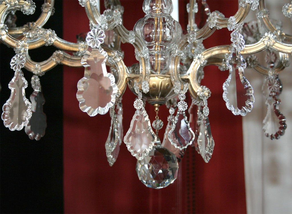 19th Century Maria Teresa gilded iron and crystal sixteen light chandelier.