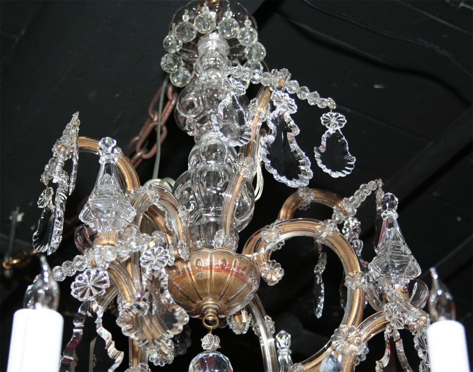 Maria Teresa gilded iron and crystal sixteen light chandelier. 4