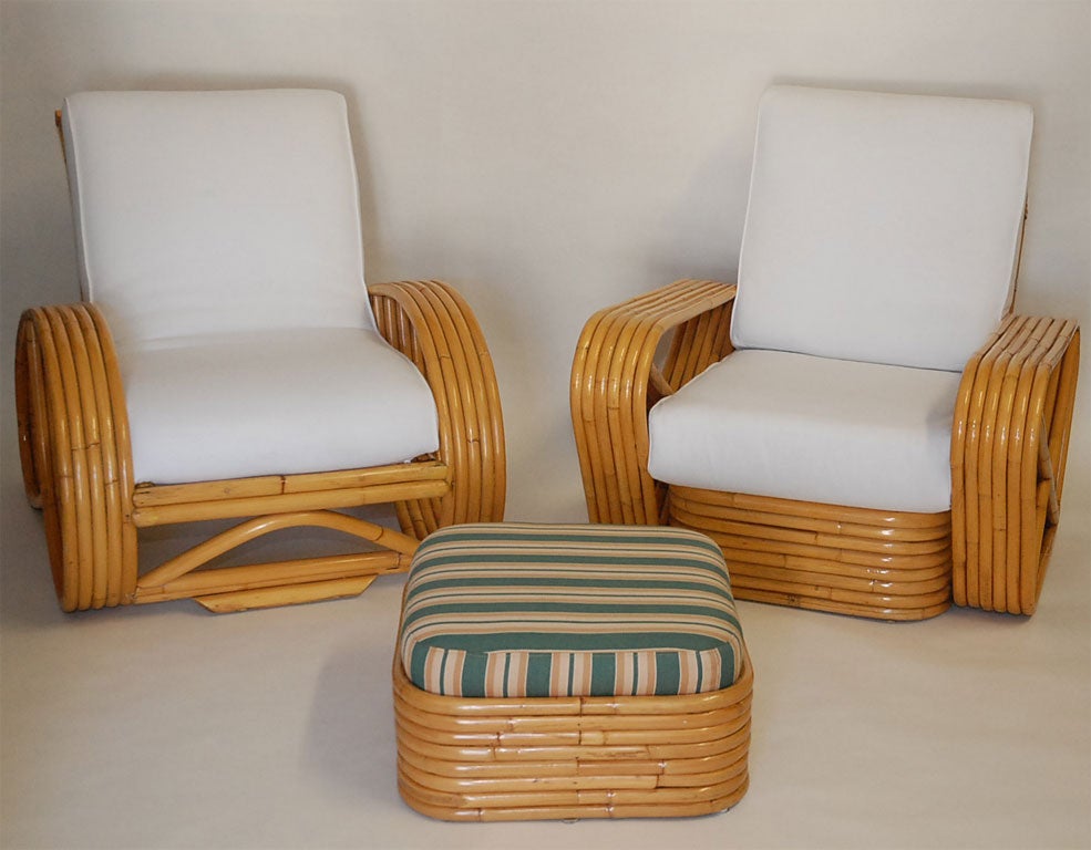 Rare pair of   5-strand (mismatched) rattan chairs designed by Paul Frankl upholstered in brushed  white denim  with matching ottoman  upholstered in vintage French fabric.