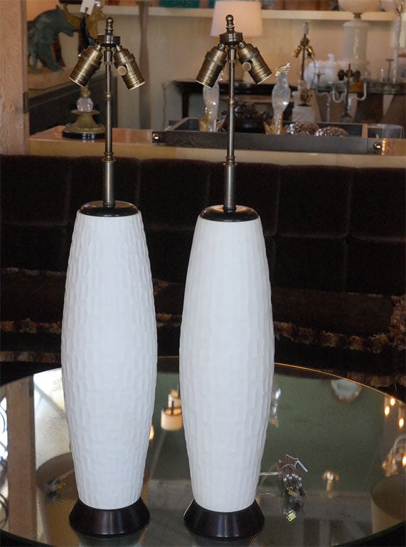 Tall pair of table lamps in a white satin or matte finish glass, chiseled pattern.