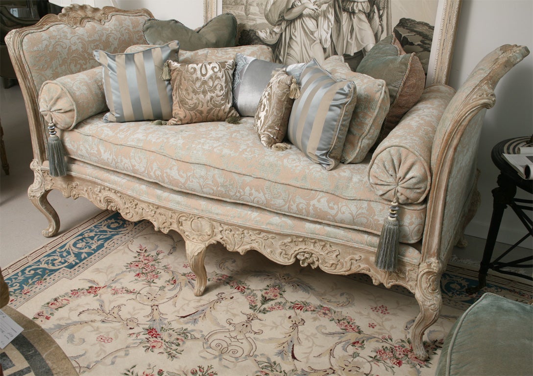 Deluxe French daybed completely reupholstered with multitude of cushions in hues of blue and taupe.