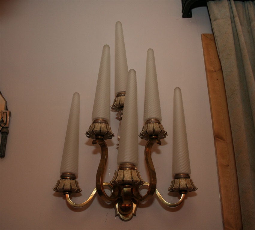 A pair of Sevres glass and gilt metal wall sconces, 

with six candlearms, ribbed frosted glass shades above, circa 1949.