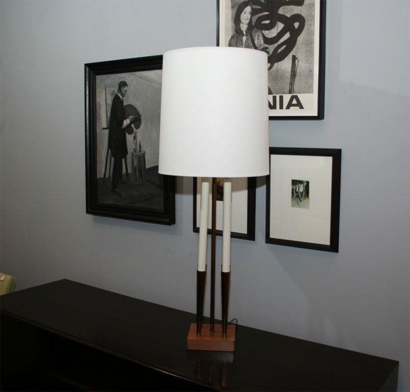 Brass candlestick Lamp mounted on blonde mahogany.