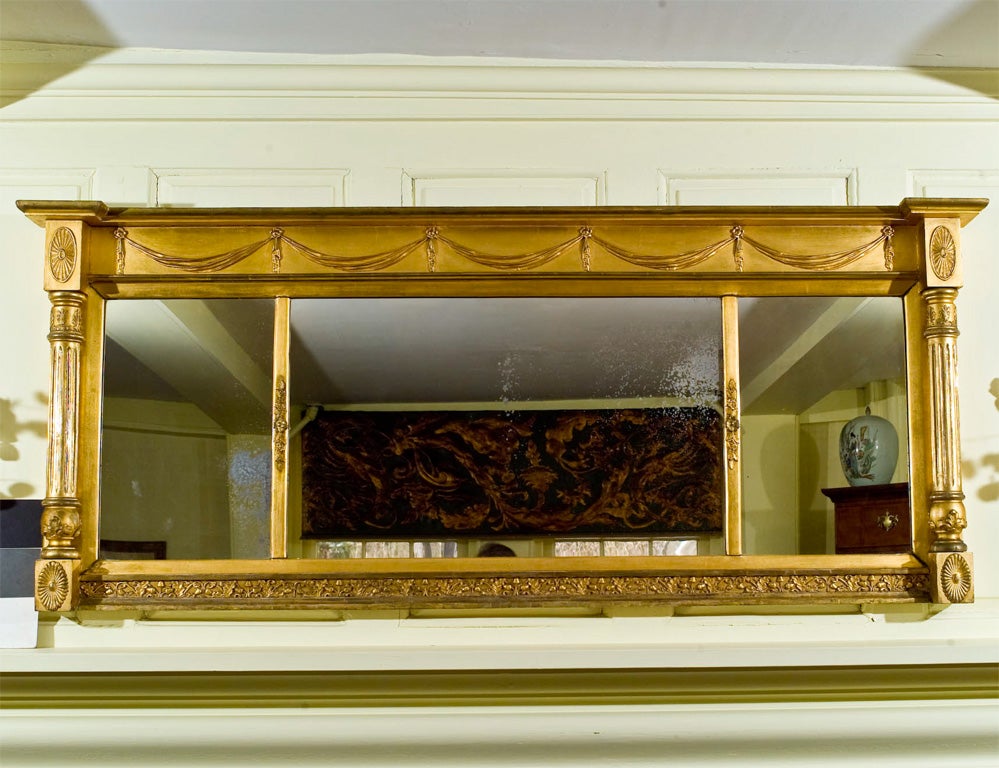 Specimen gilt-wood swag and foliate decorated mirror, for over a fireplace<br />
mantle or a dining room sideboard.  The swag motif complements the crest rail<br />
decoration of Federal and Classical  period NYC sofas from the shop of Duncan<br