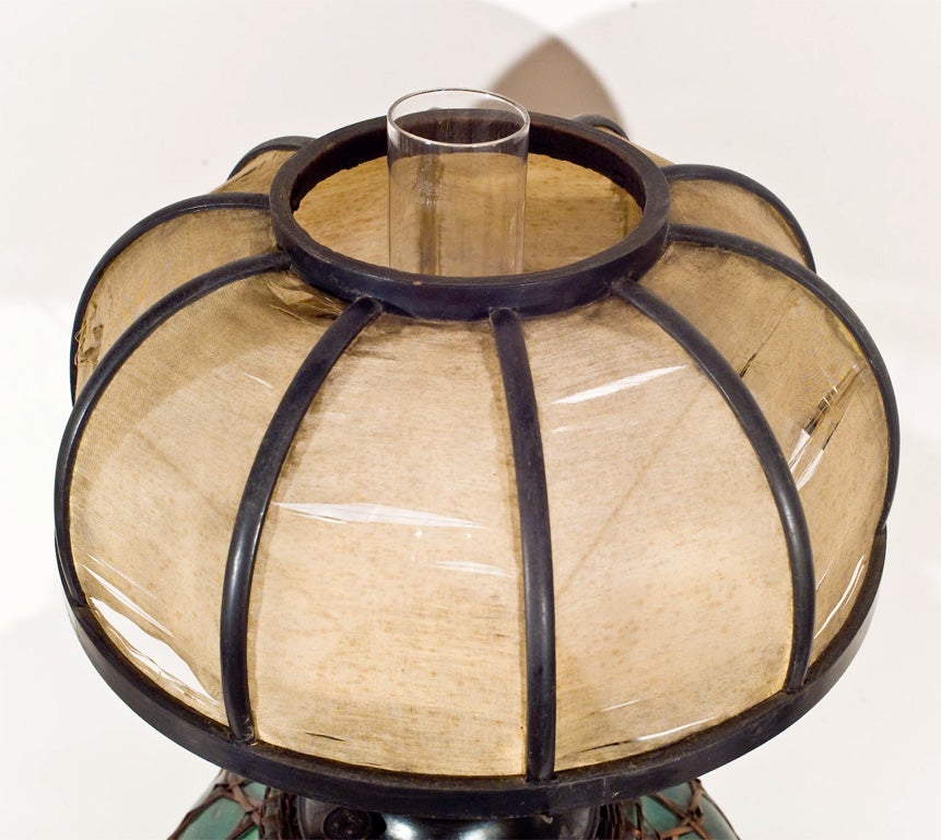 Japanese Awaji Pottery kerosene lamp with original wood framed silk shade. Pottery is encased with split bamboo weaving. Circa 1910. Silk fabric in fragile condition.