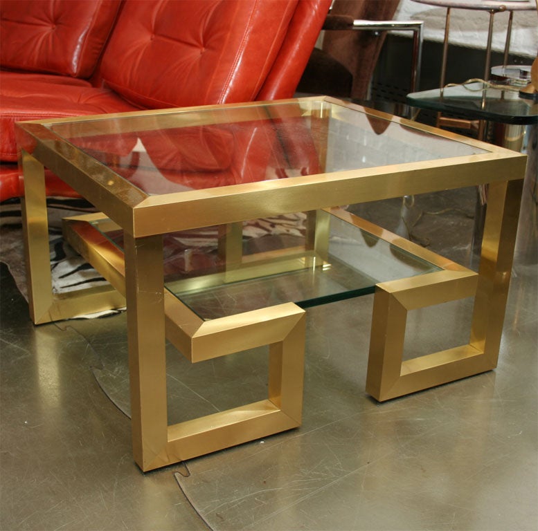 Wonderful pair of brushed brass and glass side tables. Can be pulled together to form a coffee table.