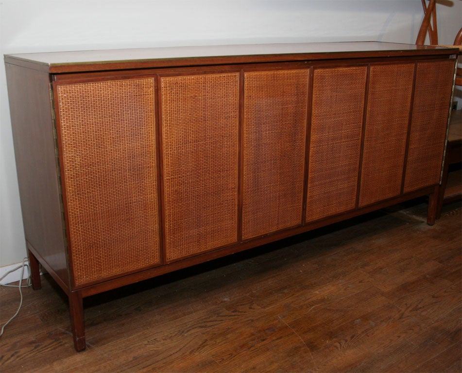 Paul McCobb caned door walnut credenza with leather top/brass trim, mfg. Calvin-1950's.