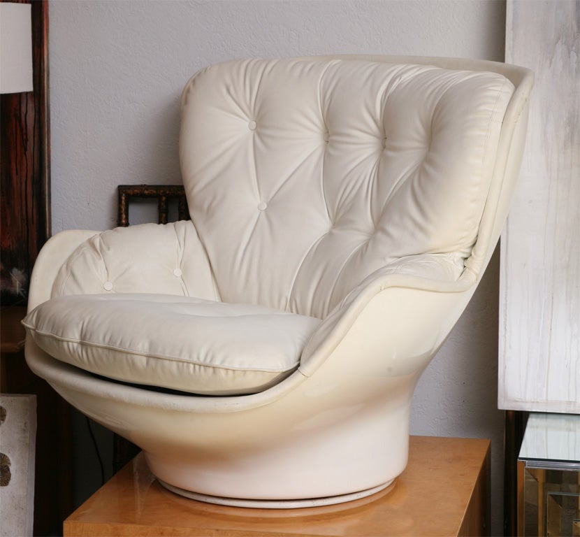 Envelope yourself in chic, 70's comfort. Polished white fiberglas swivel chair by Cesare Casati has its original white vinyl upholstery... Take a spin! Made in France.