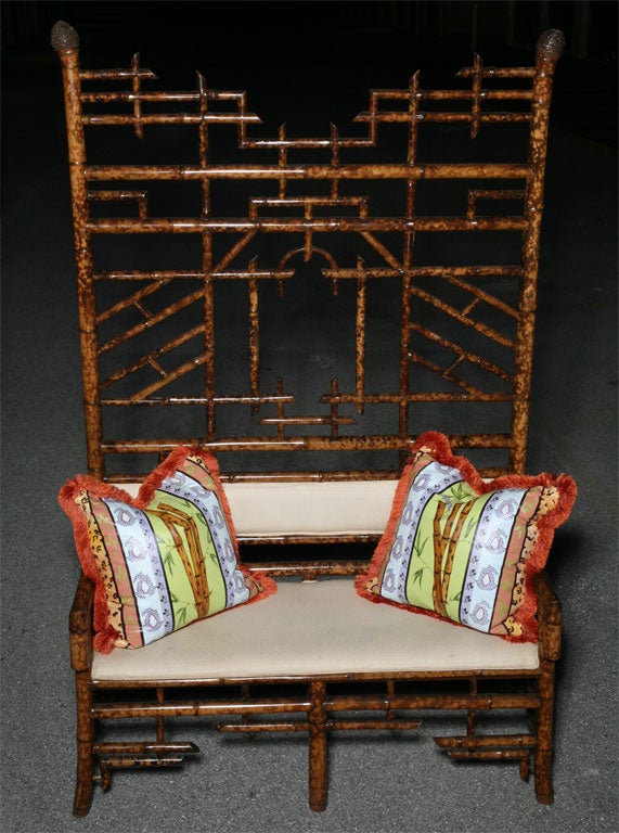 Brighton Beach Bamboo Settee with roots on posts and cushion.