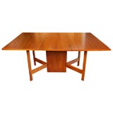 Drop leaf walnut dining table by George Nelson