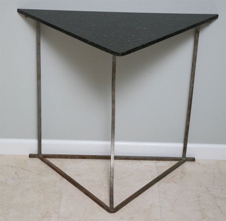 Pair of Triangular Console Tables featuring an iron base with curved profile
Supporting dark granite tops.
Great for outdoors as well.