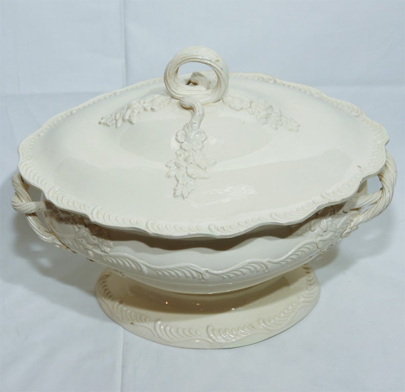 This 18th century Creamware tureen has sprigged flowers, a Feather Edge border,rope handles,and a looped rope finial.