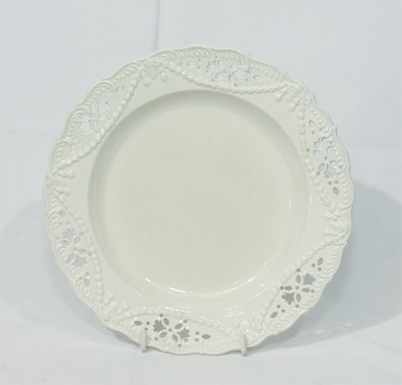 These Creamware dishes have elaborately pierced borders, with raised swags, and molded feather edge decoration.
