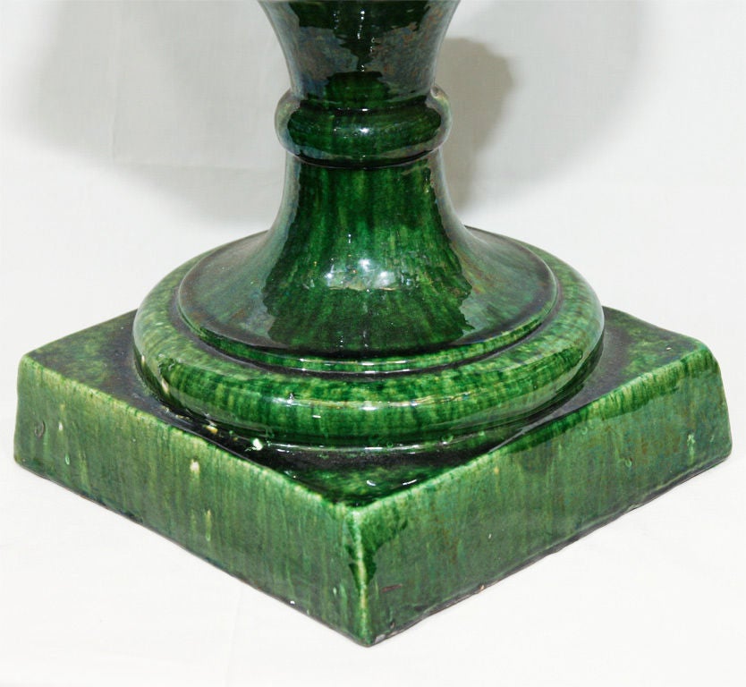 This pair of very large urns has a lovely marbleized green glaze and small lion mask handles
